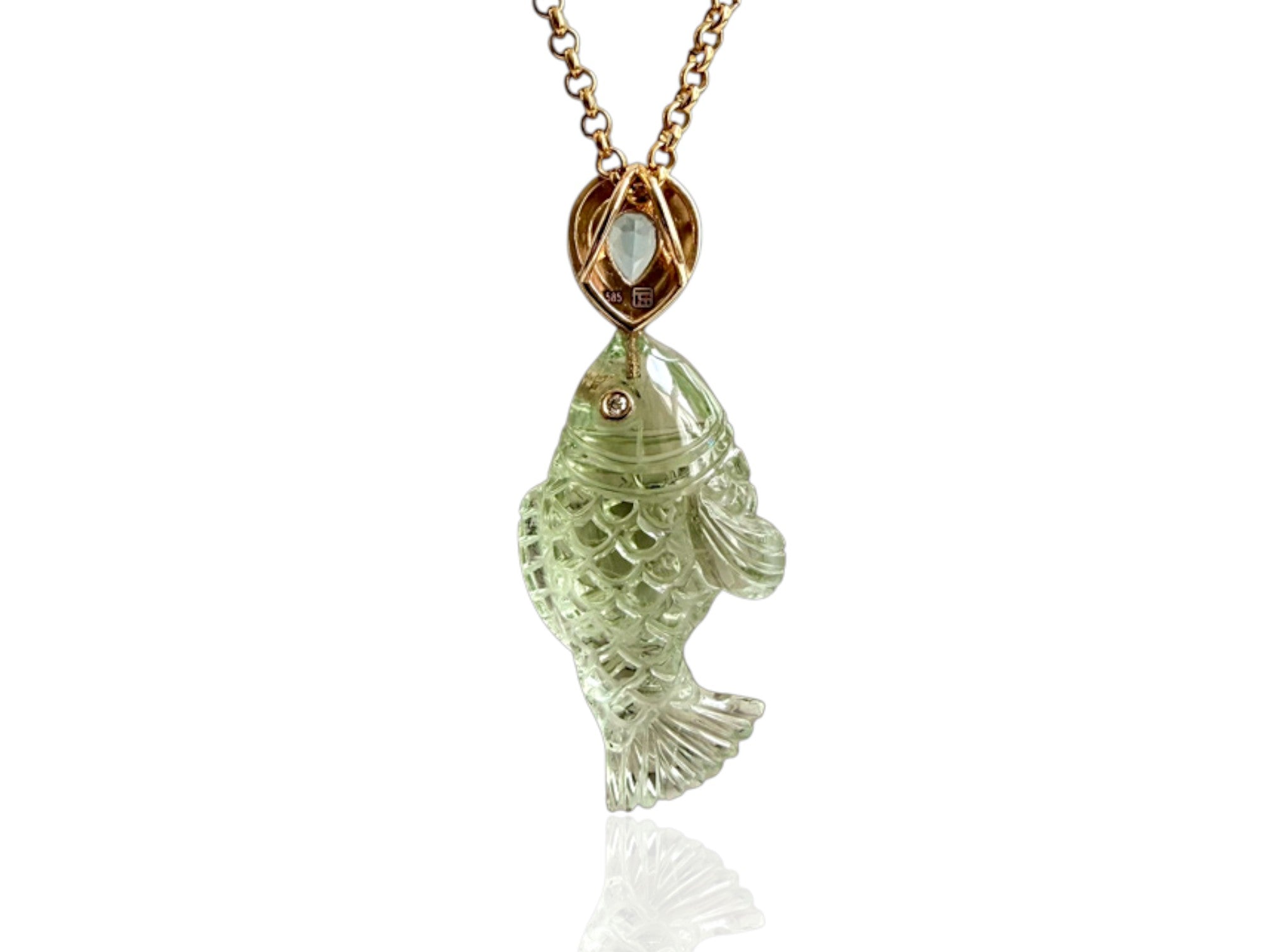 Hand carved green amethyst carved fish pendant hung from a black enamel and aquamarine teardrop