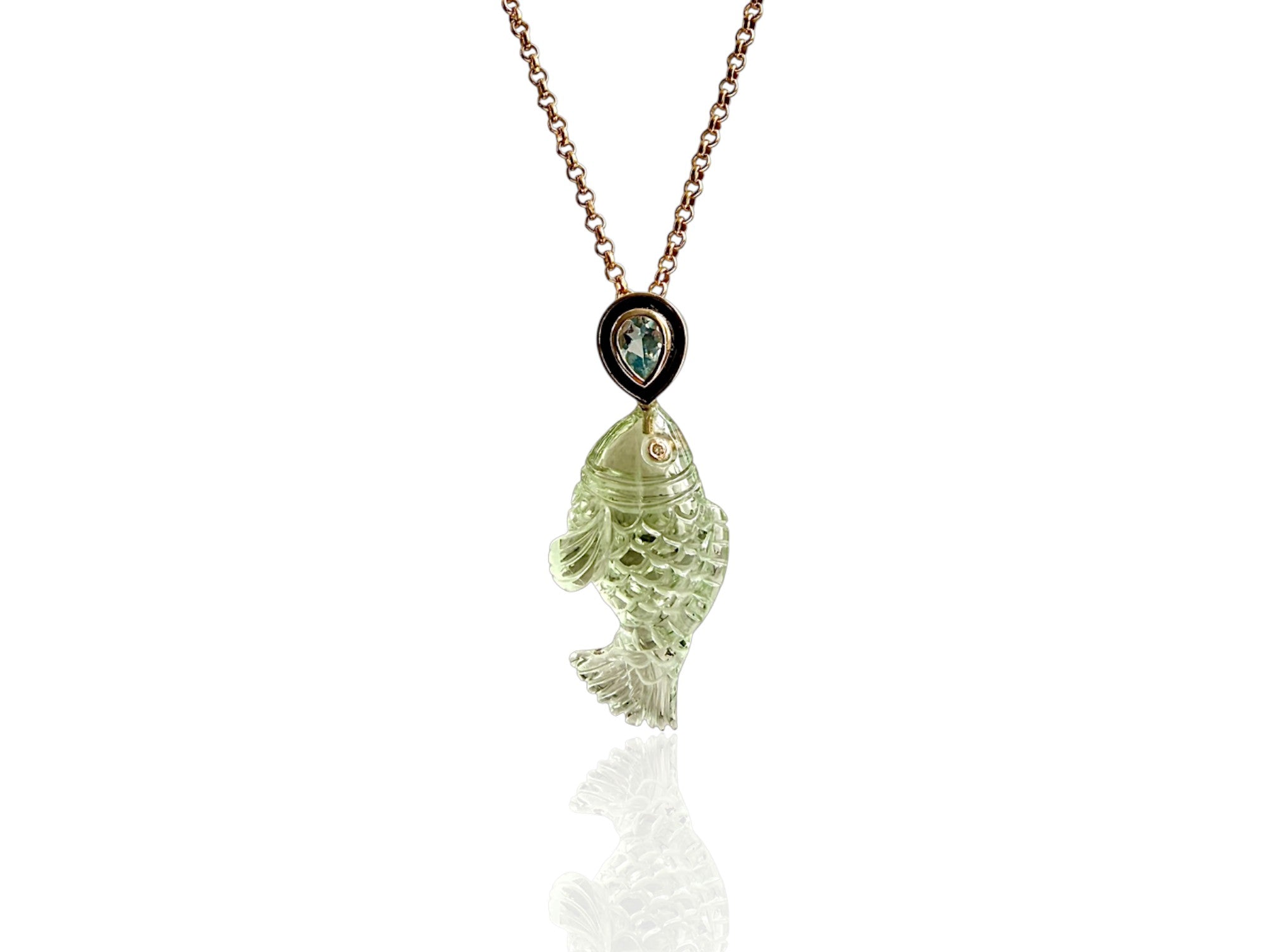 Hand carved green amethyst carved fish pendant hung from a black enamel and aquamarine teardrop